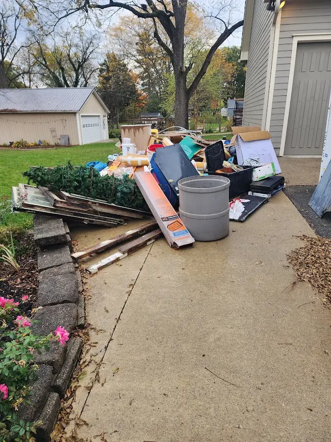 Dumpster being loaded with debris for Commercial Dumpster Rental in Glenmont